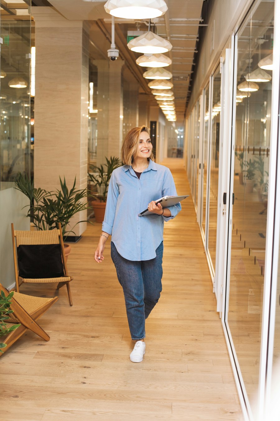 A professional walking through a bright office